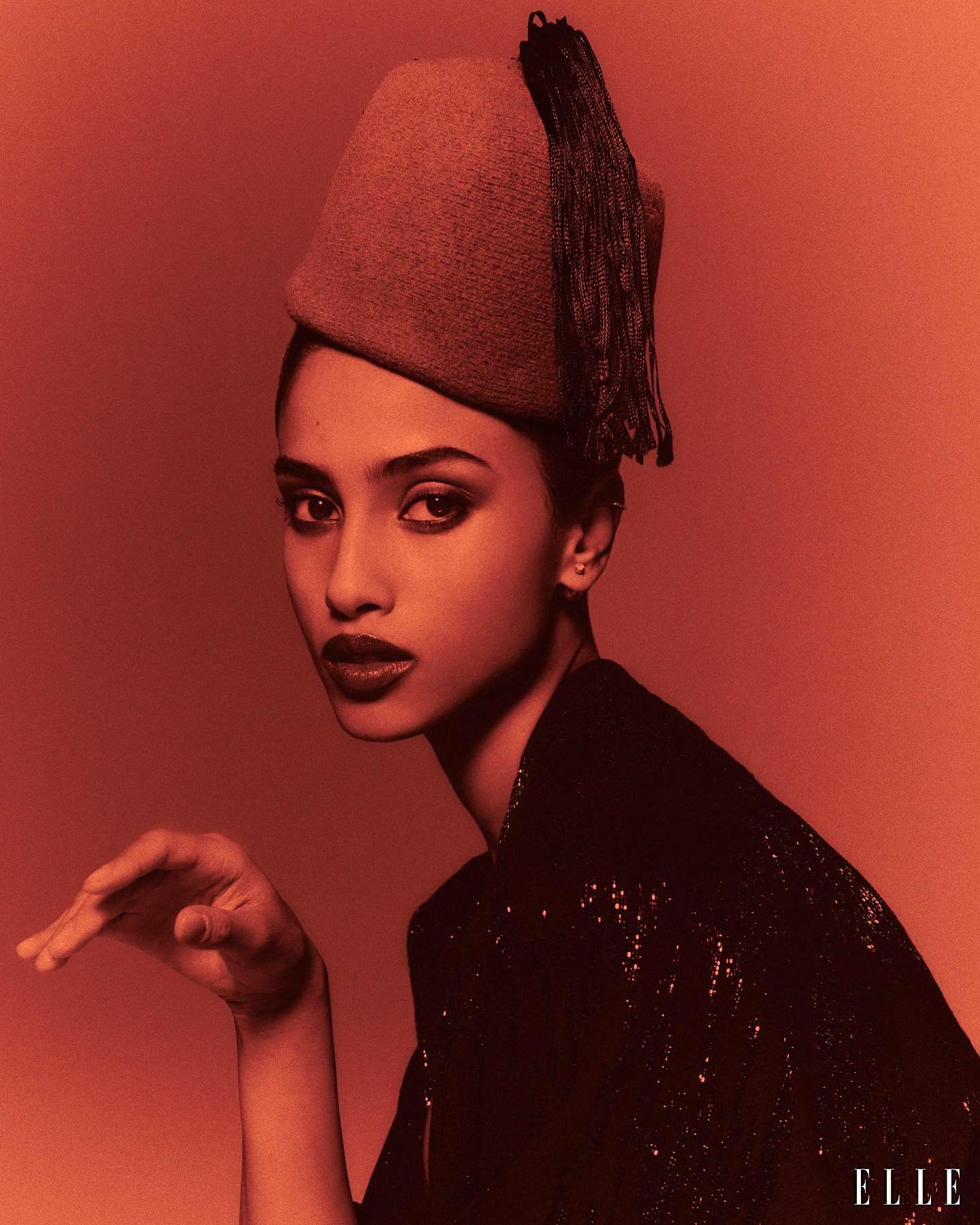 Imaan Hammam coat, earring, Dior Haute Couture; hat, Ellen Christine Couture by Chris Colls ELLE USA August 2023