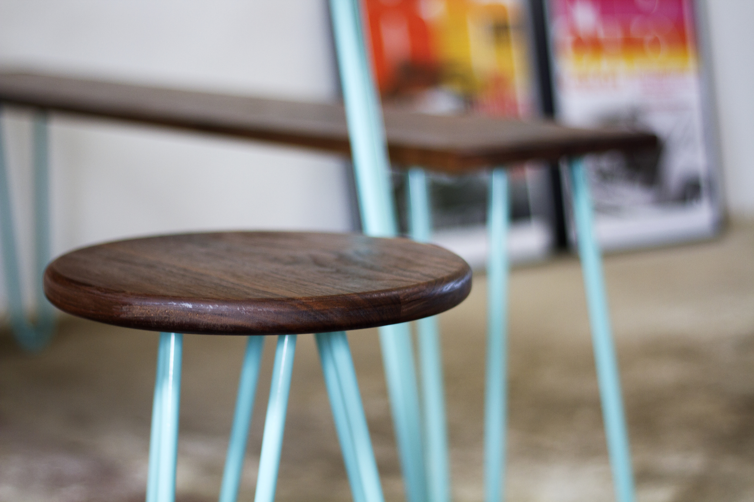 Cord Industries hairpin leg stool with walnut wood seat and turquoise legs.