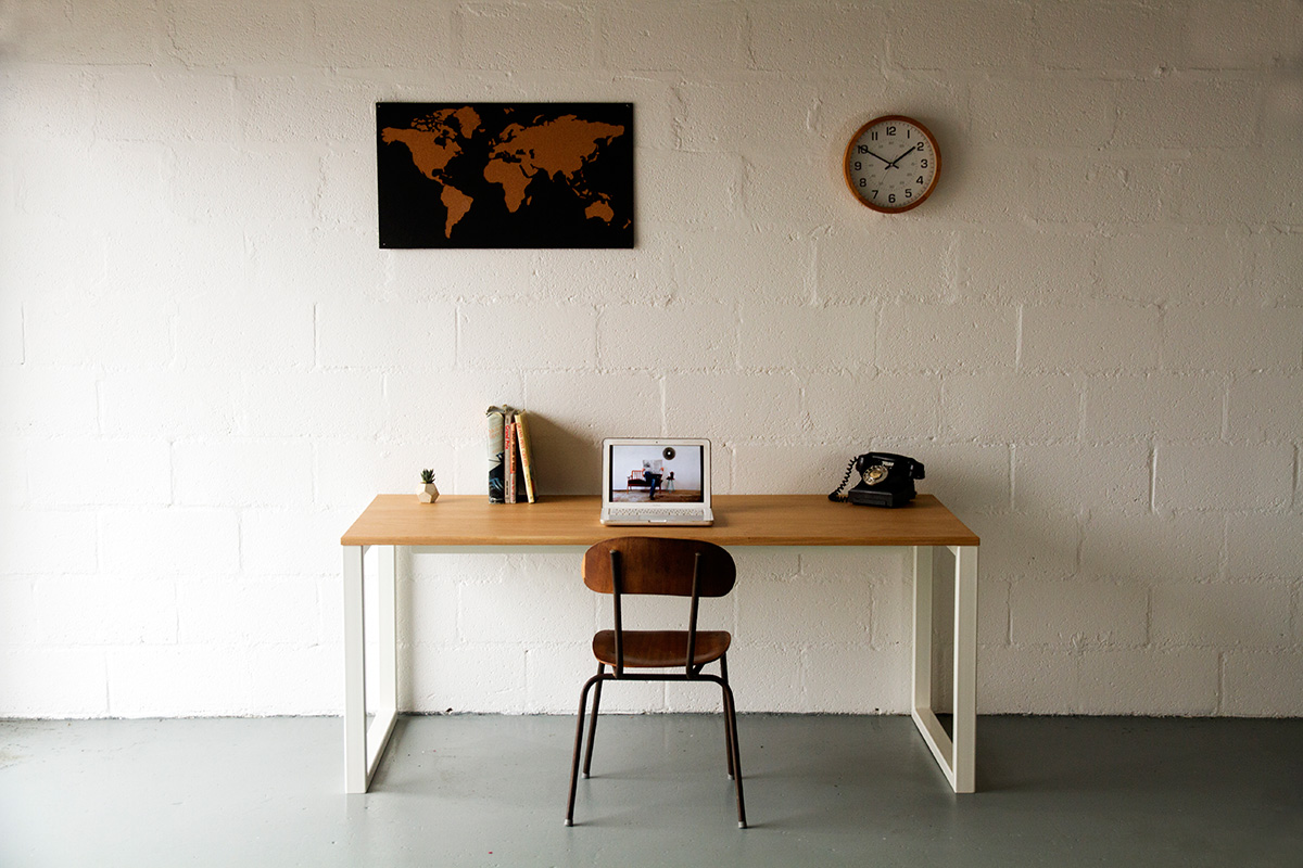 Cord Industries Nola desk table in oak with white legs.