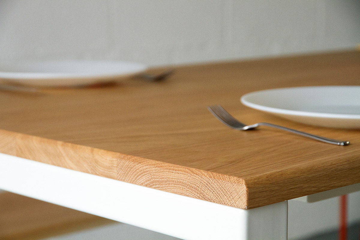 Cord Industries Nola dining table in oak with white legs (close-up).