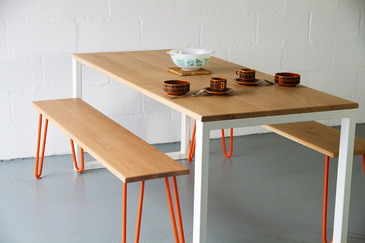Cord Industries Nola dining table in oak with white legs to seat six (shown with oak benches with orange hairpin legs).