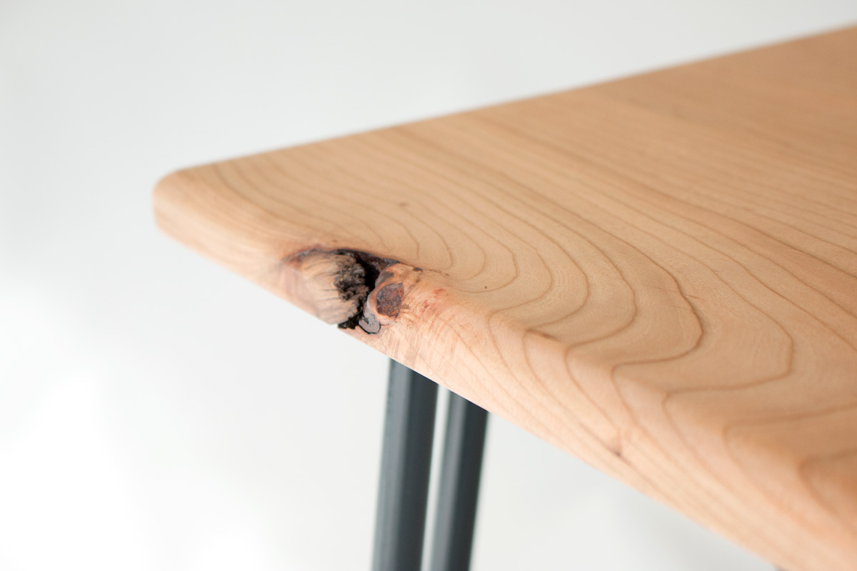 Detail of feature knot on cherry wood dining table by Cord Industries.