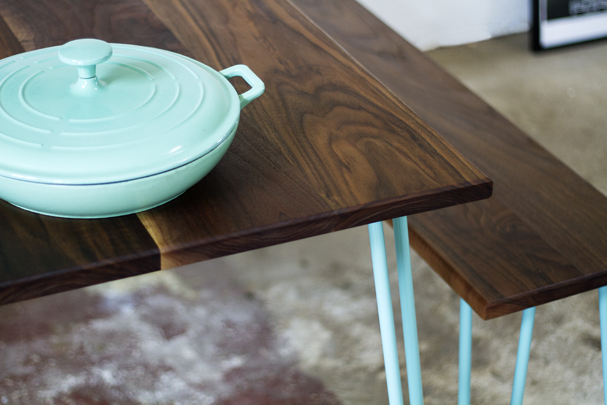 Cord Industries hairpin leg dining set for eight, in walnut with turquoise legs.