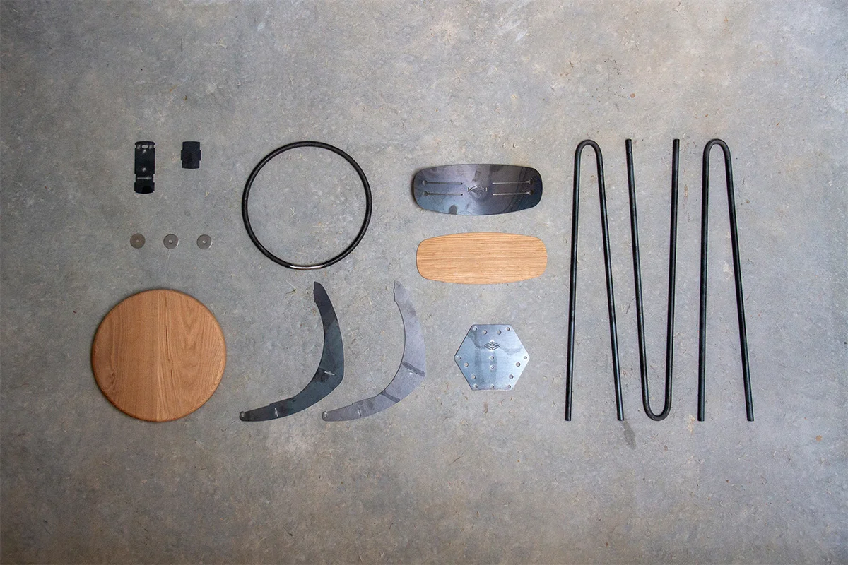 All fifteen of the component pieces for one of our hairpin leg bar chairs (in oak) laid out ready to be welded together, powder coated, and assembled.