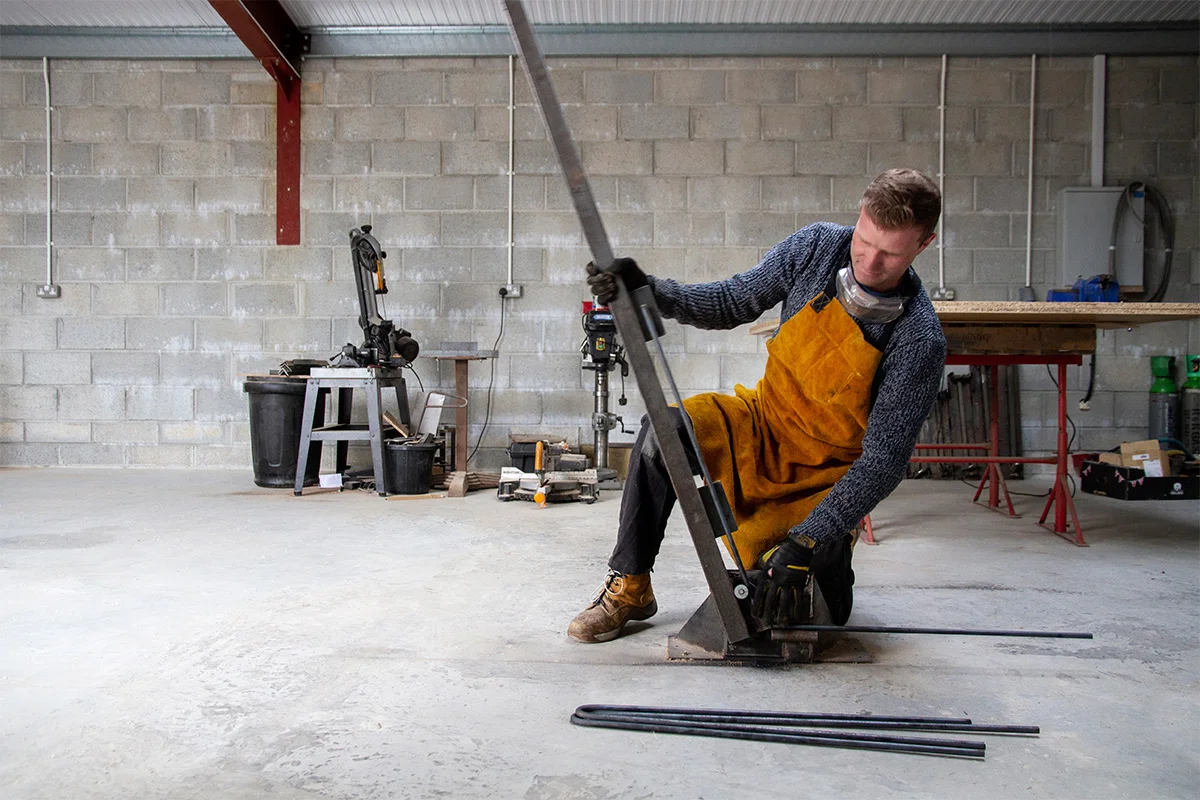 Steel rod for the hairpin legs is cut, bent by hand using a custom-made jig, and then cut again to the correct height.