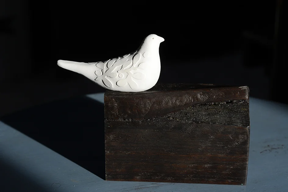 Peace, porcelain on 5,000 year old redgum, 13x17x5 cm