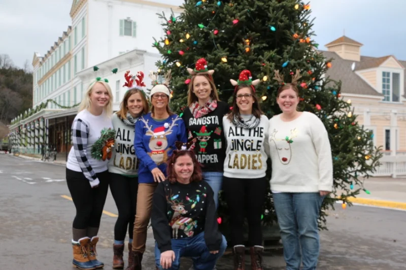 Our Joann's Fudge Christmas elves posing in front of the Main Street Christmas Tree