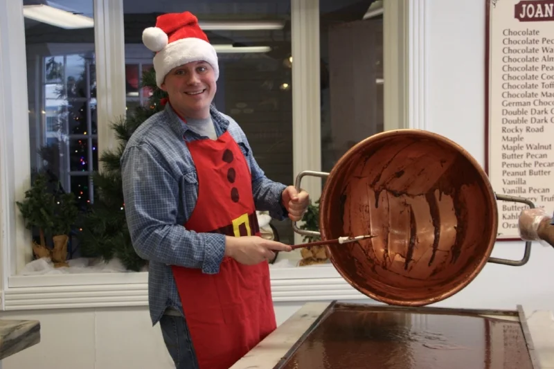 Pouring fudge from the copper kettle to the marble table.