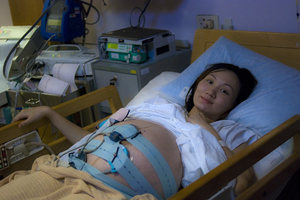 At week 30, strapped with devices and confined to the bed in Delivery Suite.