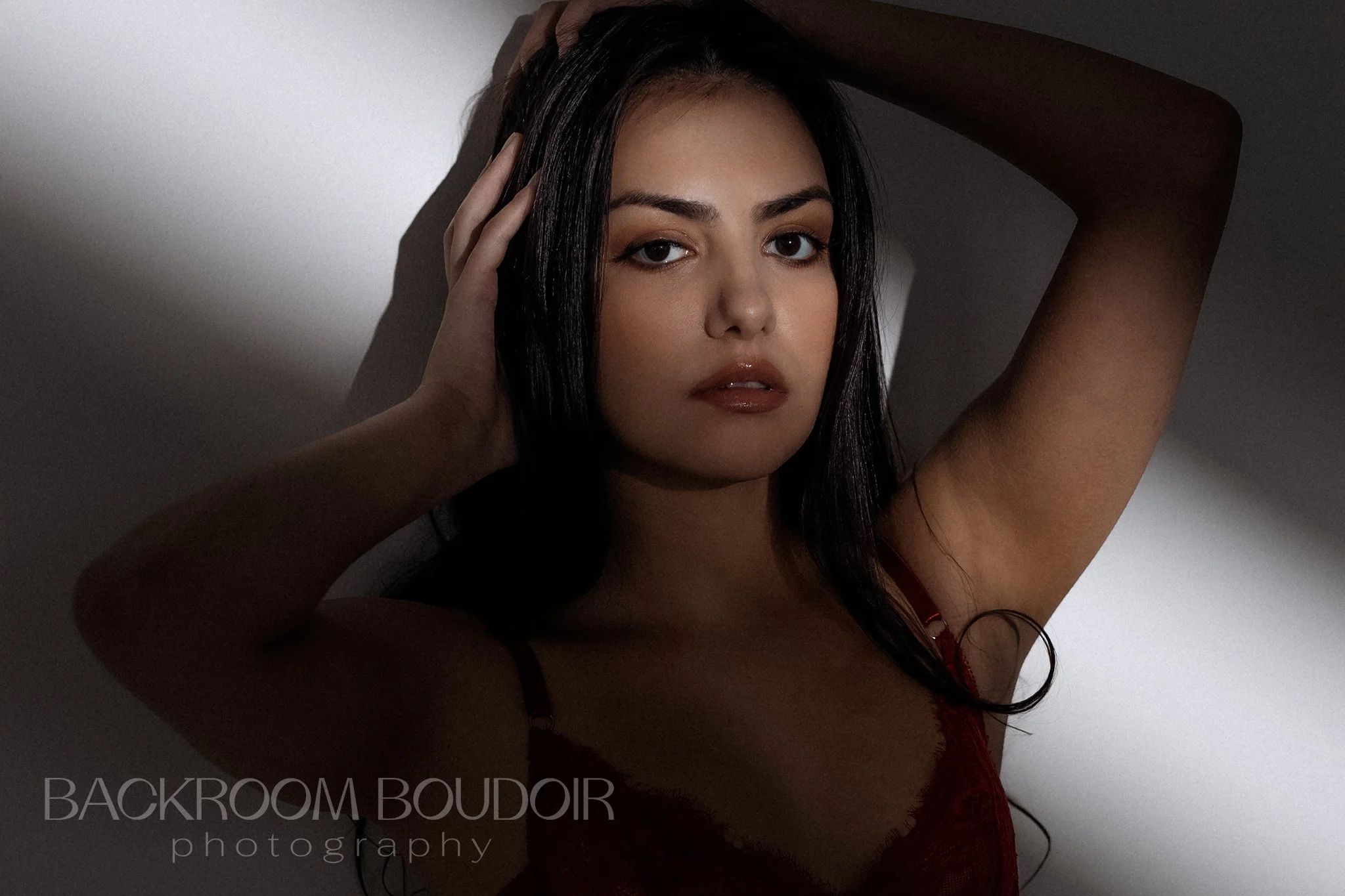 Confident woman poses in dramatic lighting