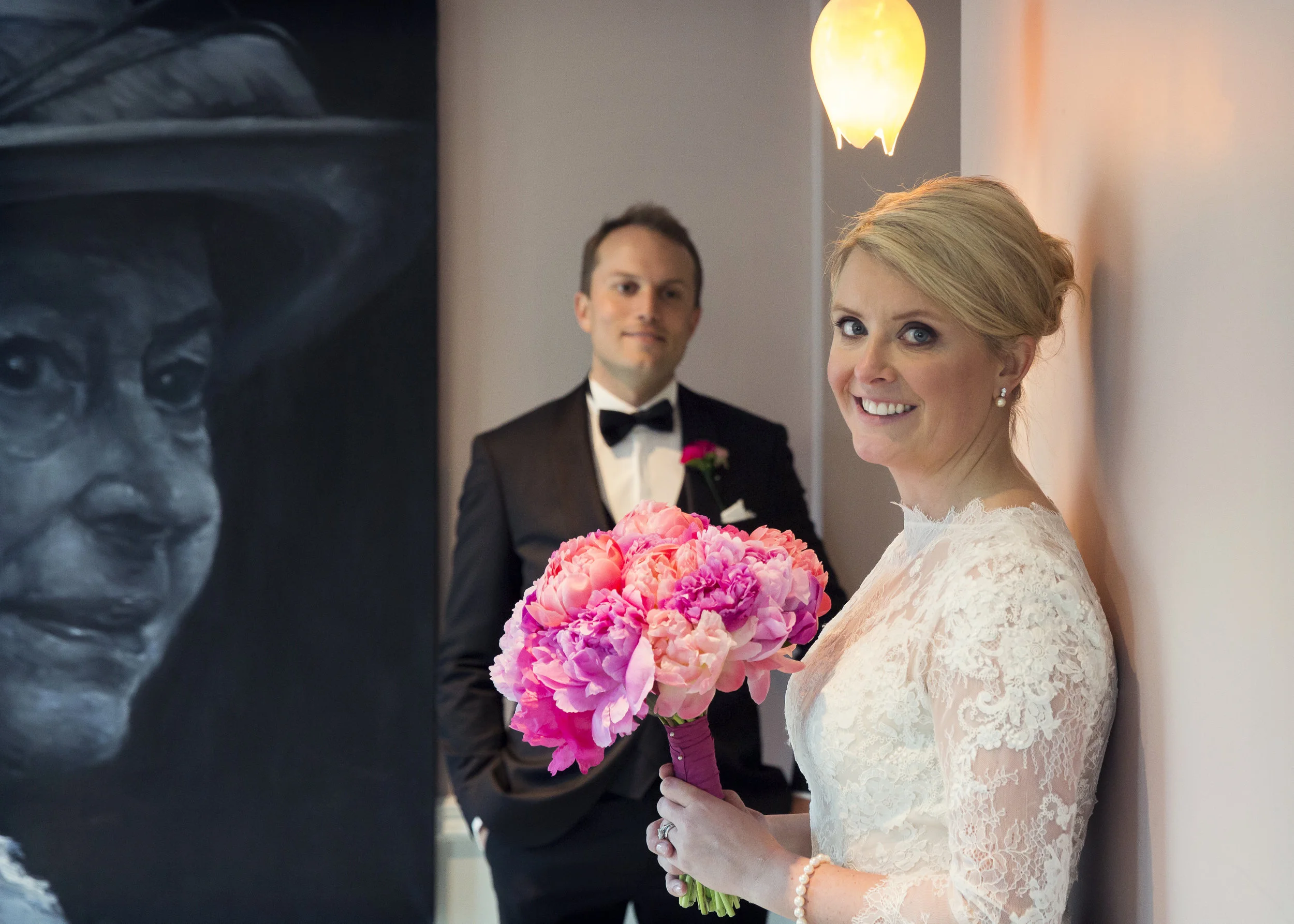 Take one beautiful bride, one handsome groom and one of London's hippest hotels, and you have the perfect recipe for a stunning wedding! I was so excited when Galen told me that she and Richard were having their wedding ceremony and reception at Ham Yard Hotel . Having had my own reception at one of its sister hotels, the Covent Garden six months previously, their choice struck a real chord with me. Ham Yard is part of the Firmdale hotel group, and all are renowned for the individuality and quirkiness of their interior design. Galen's choice of vibrant jewel toned Spring flowers was a perfect compliment to the hotel's striking interiors, where, when it come to dressing the venue you just have to "go with it"! The Windmill room, with its botanical wallpaper in shades of black and grey was the setting for both ceremony and reception. Against this monochromatic backdrop, the vibrancy of the flowers shone through. I think the tablescape for Galen and Richard's wedding, captured so beautifully by Peartree Pictures has to rank as one of my all time favourites. I absolutely adore the jewel tones of the flowers and glassware banked enmasse down the centre of the table. Peonies, anemones, celosia, ranunculus, sweet peas, geulder and roses all jostling for space, like the busy streets above. I love this picture so much I've set it as the wallpaper on my 'phone! For the reception, the natural wood of the unclothed table was the perfect base for the flowers, adding warmth to the setting The river of colour running the full length of the table draws the eyes to the centre of the room. With the lighting dimmed and the candles lit, the mood for the evening was warm and inviting. Perfect for an intimate celebration. Ham Yard's stunning roof top garden was the perfect place for Galen and Richard's post wedding photos. High up among the sky line of Soho, this green oasis is a world away from the hustle and bustle of the streets below, but here all was calm, and against the green back drop Galen's show stopping bouquet of peonies added an amazing punch of colour.