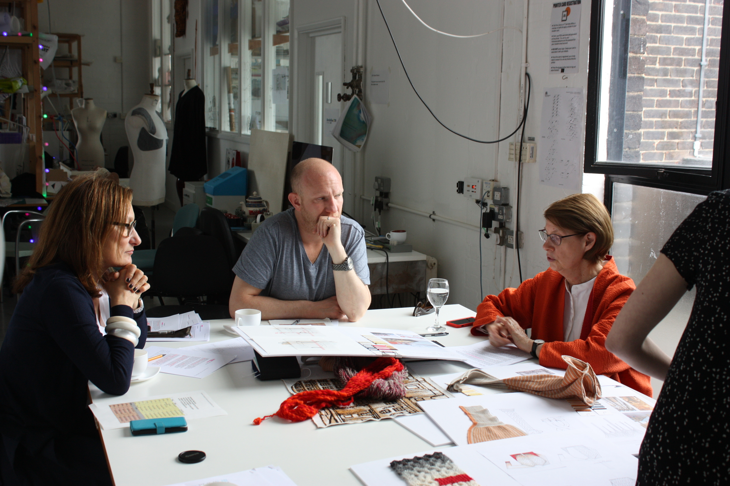 Julia Pines, Matthew Cosserat and Mary Restieaux discussing student's work.