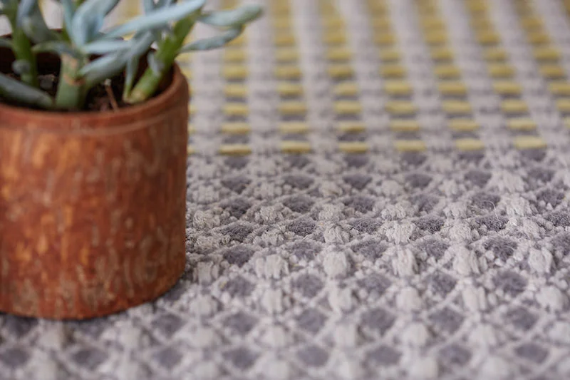 yellow embroidery on light grey base