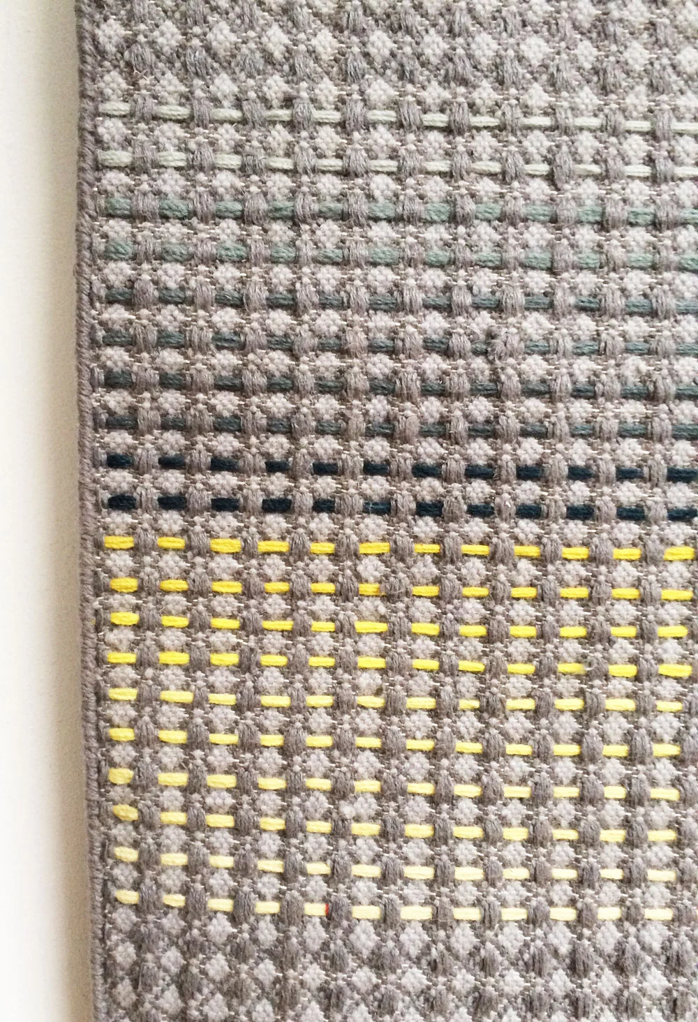 Yellow and teal embroidery close up detail