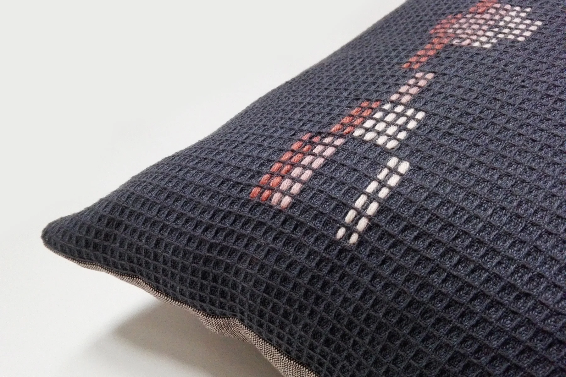 Navy and coral hand embroidered organic cotton square cushion