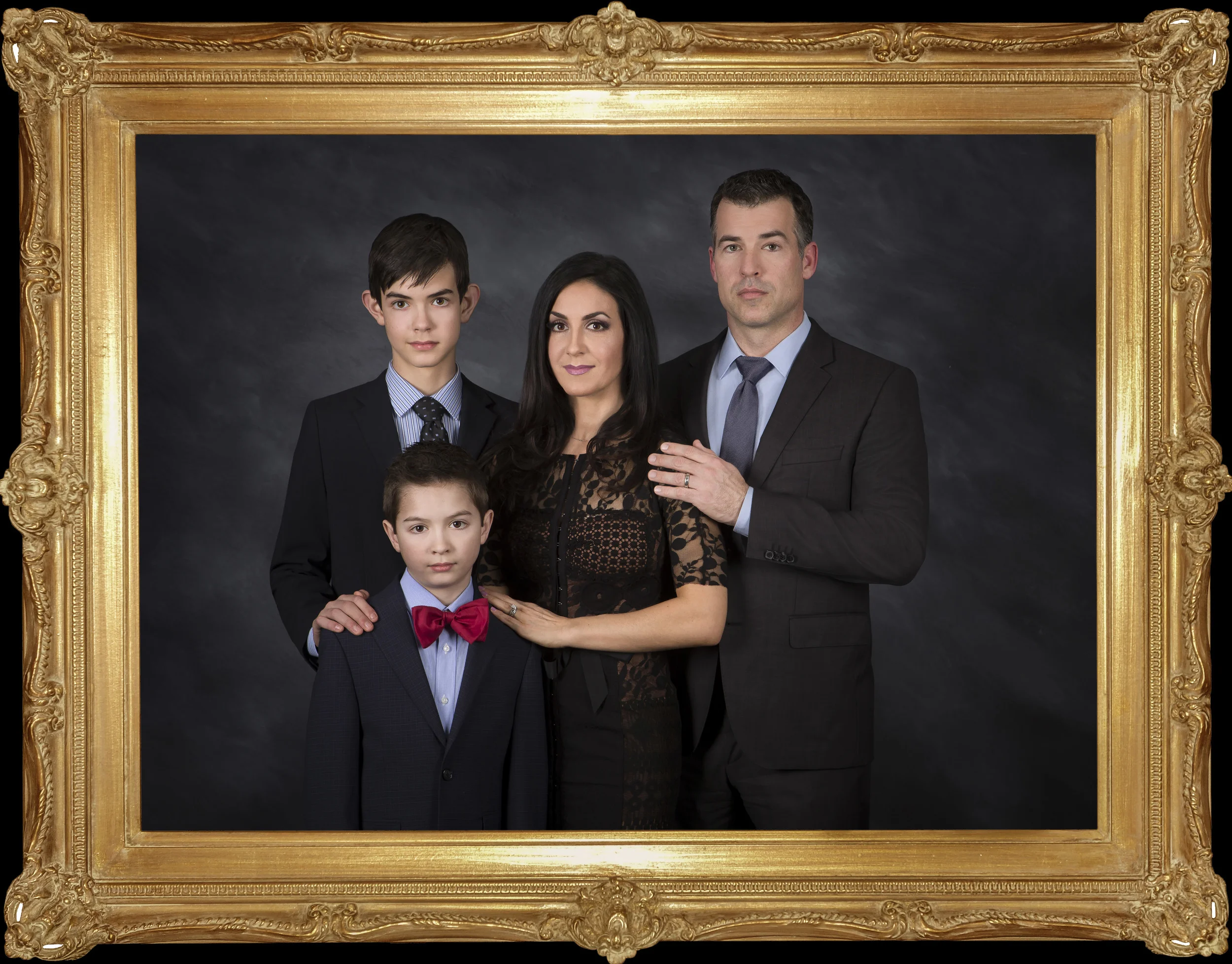 Dress Code As a specialty studio, our background and lighting are exactly calculated to render your portrait as an exquisite piece of art . It is important for the success of your portrait that certain styles and colors of clothing be used , while avoiding other styles and colors. We ask that you please dress formal. For many, this becomes the most elegant portrait they will possess in a lifetime. Most portraits do not drop below the knees. In general, we ask that you wear dark clothing so as to keep the light reflecting on the face and eyes; not the clothing. Jewel toned clothing works best - burgundy, red, dark green, navy blue, black. Our contoured lighting , and fine art hand painted canvas background does not work with light color tops. Our experience suggest that the following works best: Men - Dark Jackets (tuxedo or suit), white shirt, tie, and dark pants. Ladies - Dark ( black, navy, burgundy, dark green, etc. ) dress or gown. White lace around collar is okay. Little or no pattern is preferred. Classic Jewelry such as diamonds, pearls, etc. are encouraged. Young Girls - Dark or jewel toned solid dresses are preferred, but ivory, cream or off white are also acceptable if they are 4 or under. Long sleeves are recommended for adults, but girls usually are preferred to have short or no sleeves. Young Boys - Same as men, or a solid dark sweater. If under 4, a white shirt with bow tie can be appropriate.