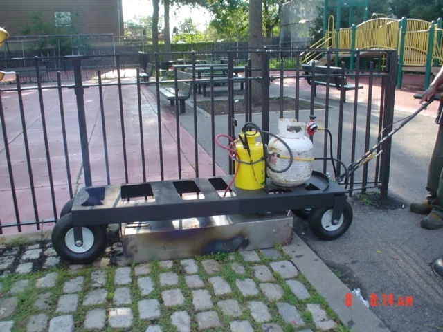 Wagon being applied to weeds in pavers