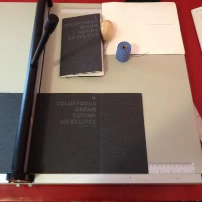 Drew Swenhaugen, book layout design wing of Octopus Books, and the book-maker and editor of its imprint, Poor Claudia , has just finished up folding and sewing, with his own bare hands, the beautiful, screen-printed cover, limited-edition (of 150) chapbook by Elaine Kahn, A Voluptuous Dream During an Eclipse (Poor Claudia 2013). It is now available to the most general public. Note : If you bought a subscription to OB/PC, you already bought this little number.