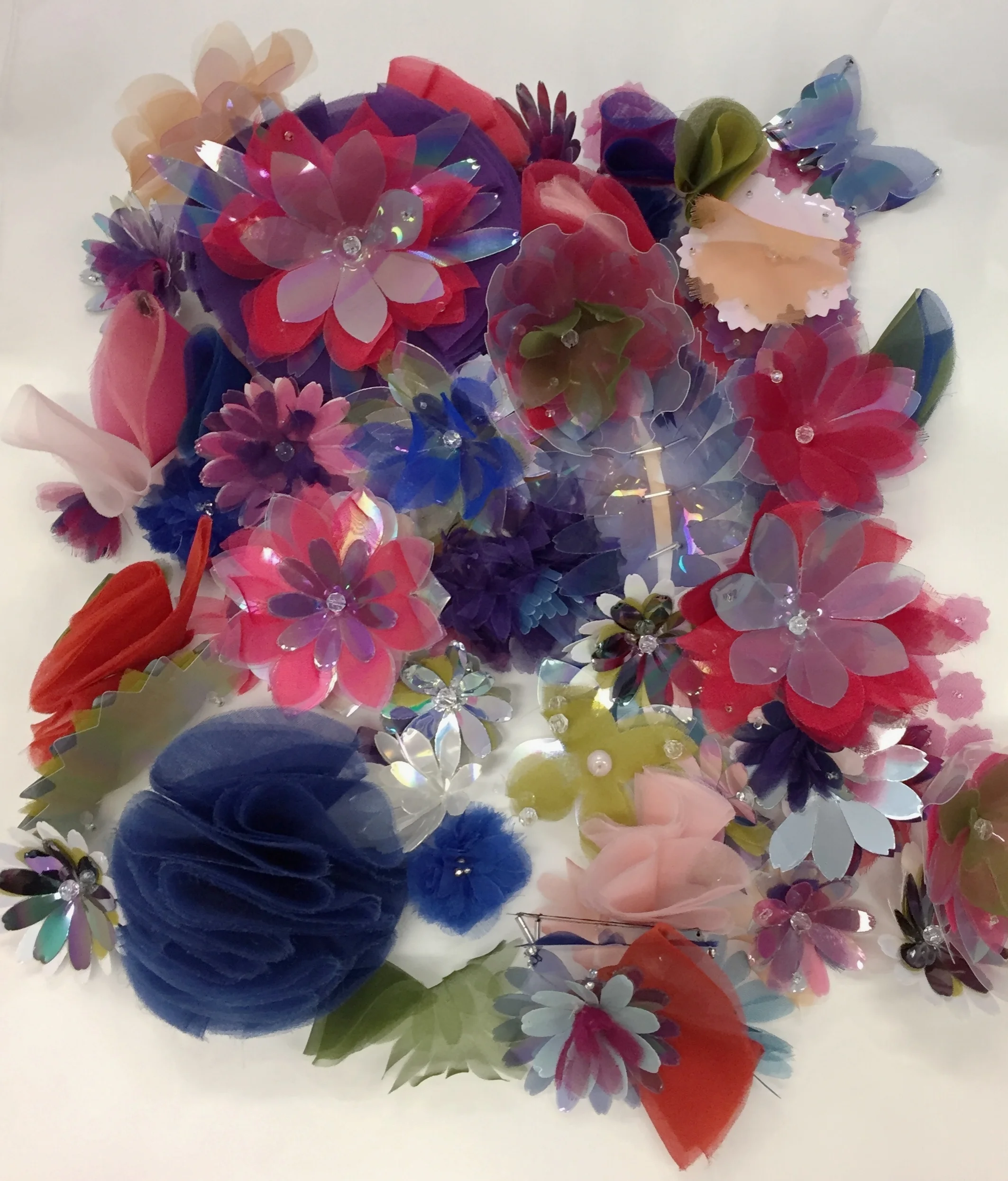Grouping of colourful plastic flowers handmade Lemarie atelier Paris fashion experience tours group trips