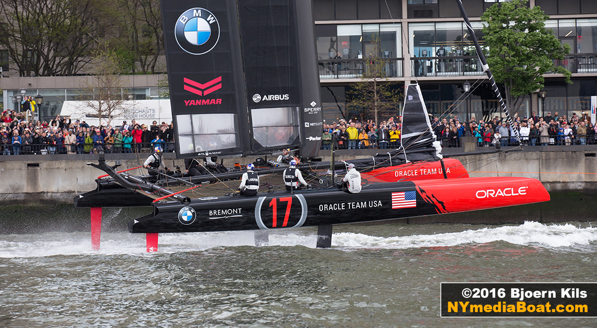 ORACLE Team USA gets towed past the crowds at North Cove Marina.