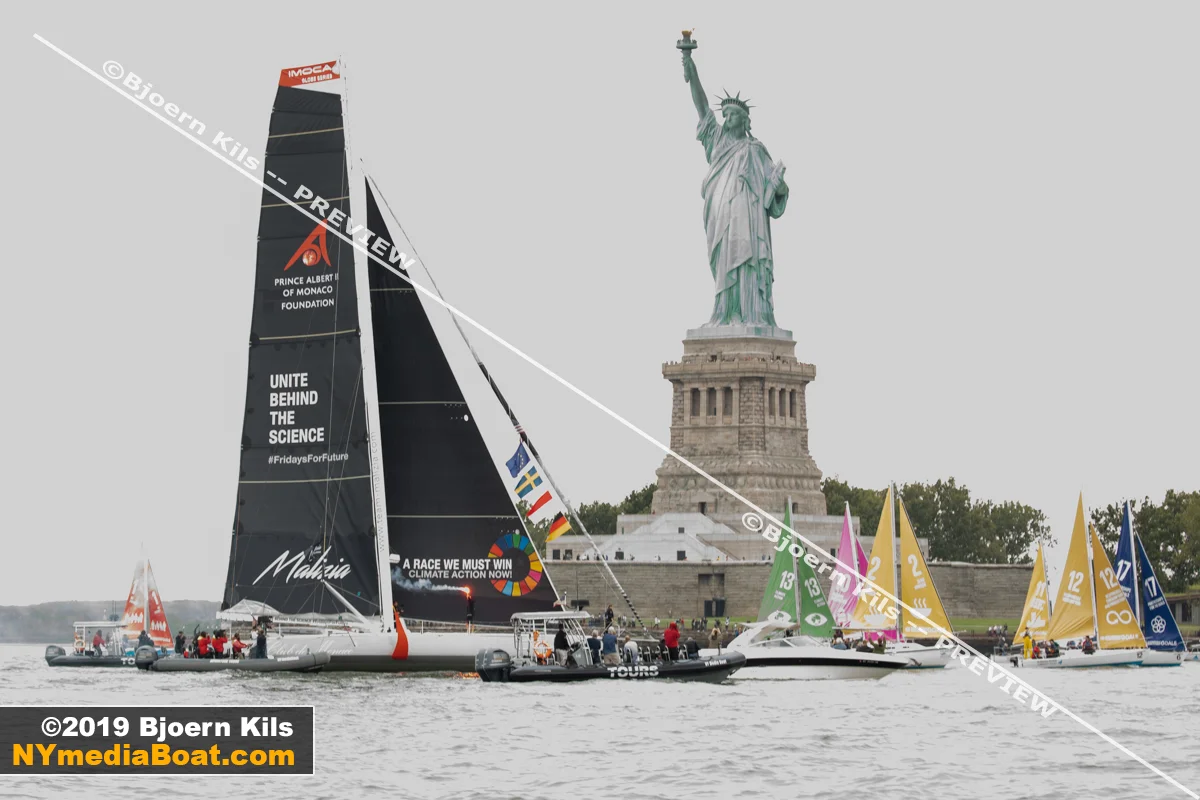 The United Nations arranged a sailboat flotilla to welcome Greta with colorful sails.
