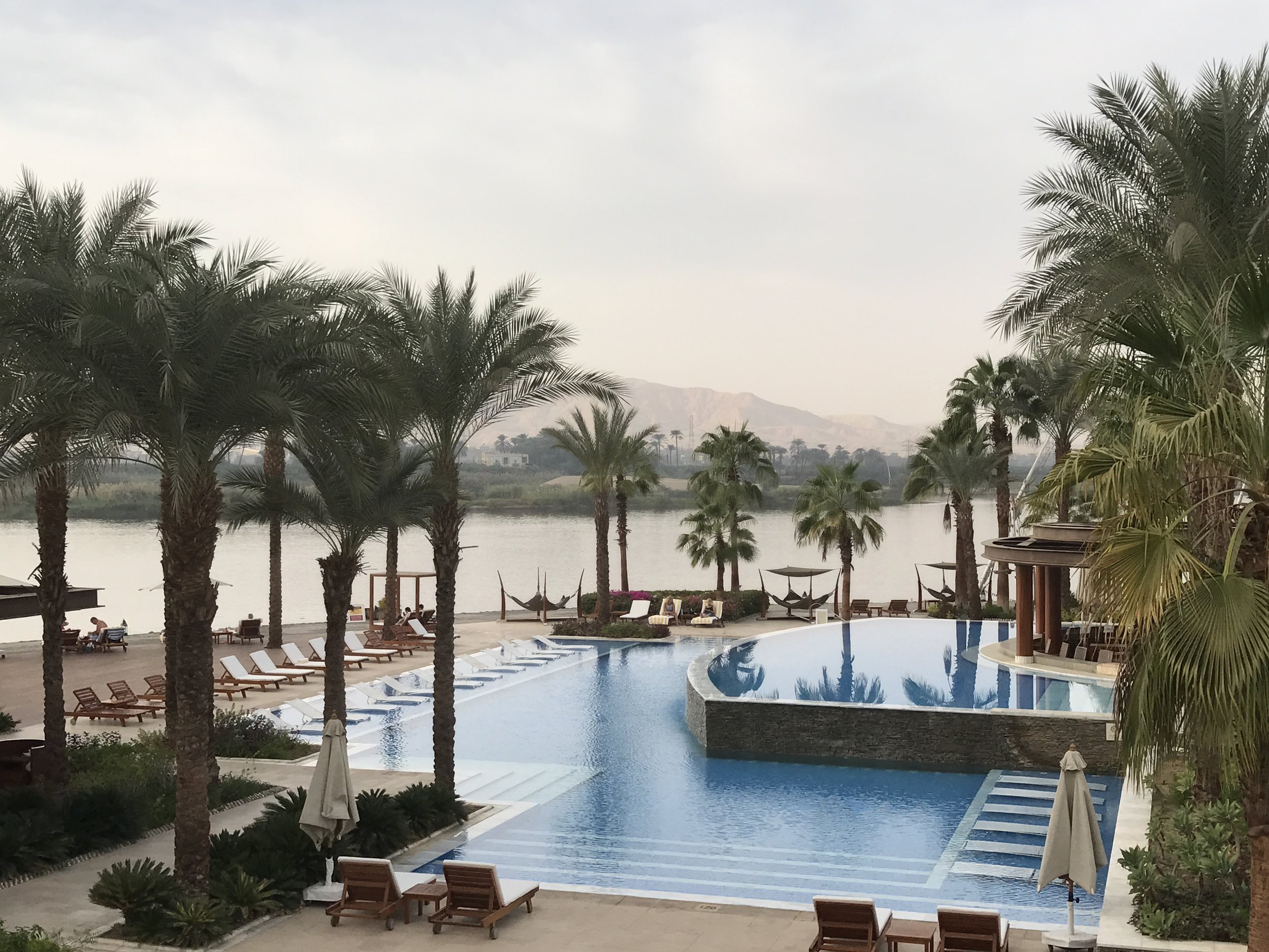 The pool area of the Hilton Luxor Resort and Spa is right next to the Nile River, with a view of the West Bank.