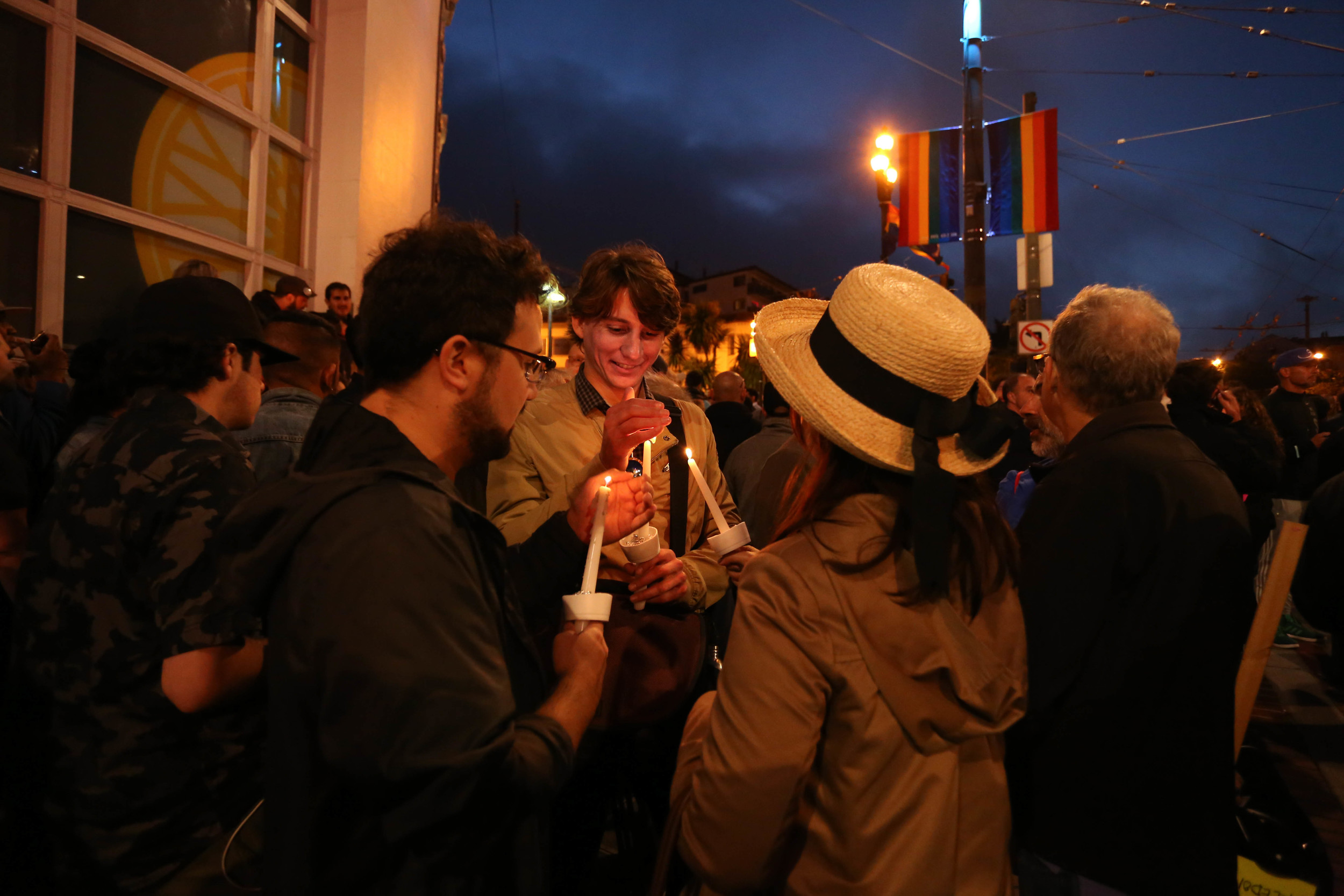 Eric Easley lights a candle during a vigil in Harvey Milk Plaza to remember the victims of the Orlando shooting. 