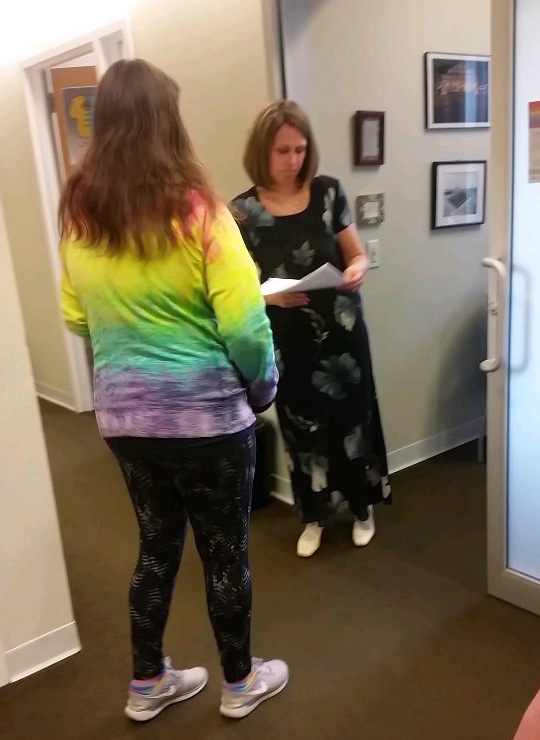 A No Red Tape organizer handing Dean Kromm the signatures from our petition.