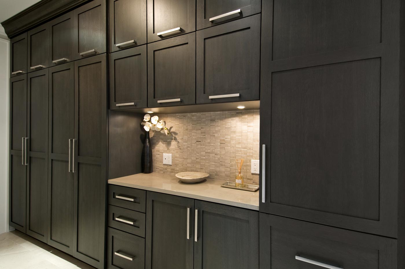 Being the home of a very active family, they wanted to be able to store everything: sport items, fishing poles, etc., so we built these floor to ceiling custom cabinets.