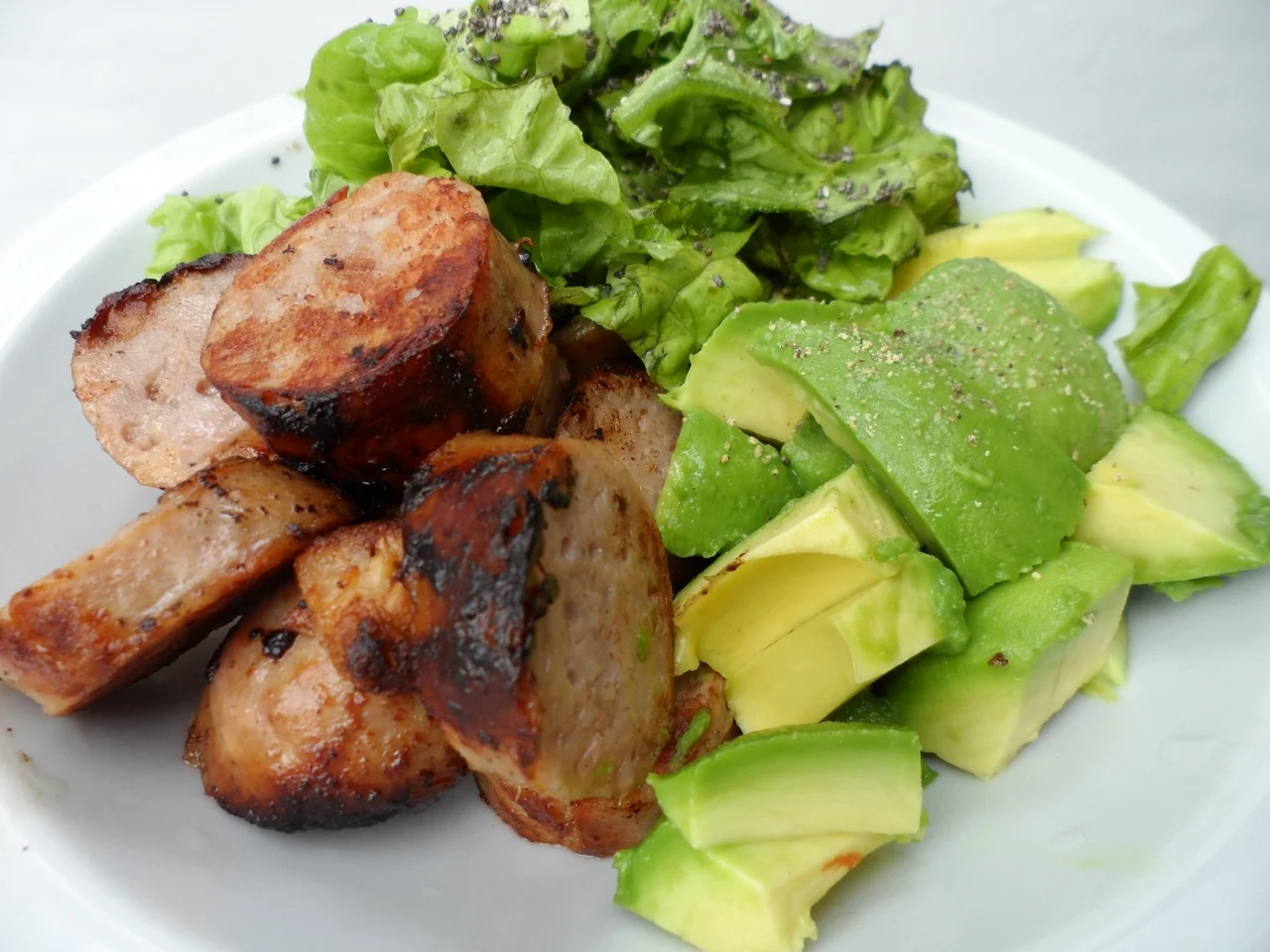  Pork Sausage, 1/2 avocado, salad greens topped with red wine vinegar, olive oil and chia seeds.&nbsp; 