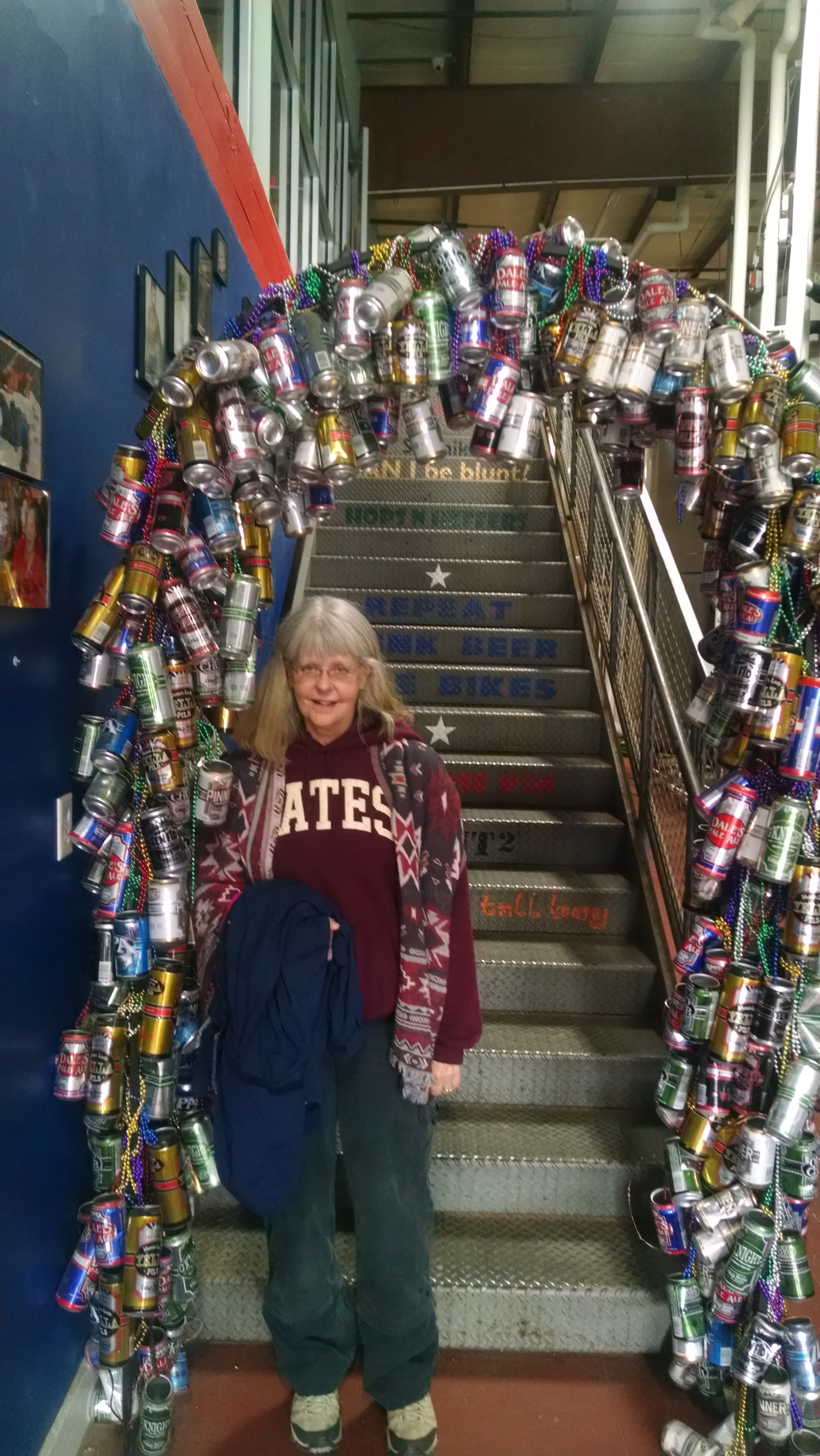 Susan surrounded by empties (not hers!) at Oskar Blues in Brevard