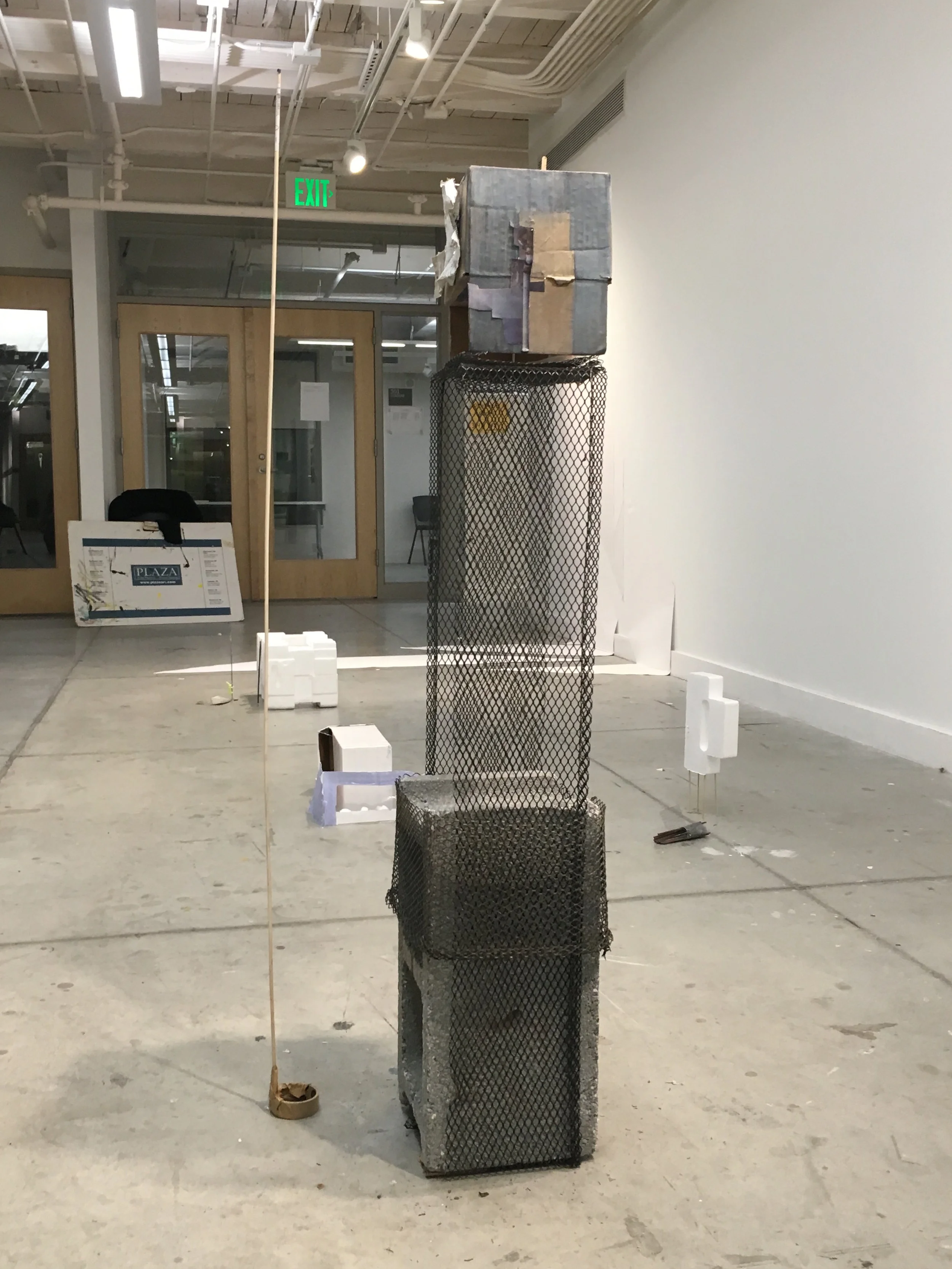  2017. Cardboard, cement, metal, paint, photographs, plastic mesh, wood, zip ties. 