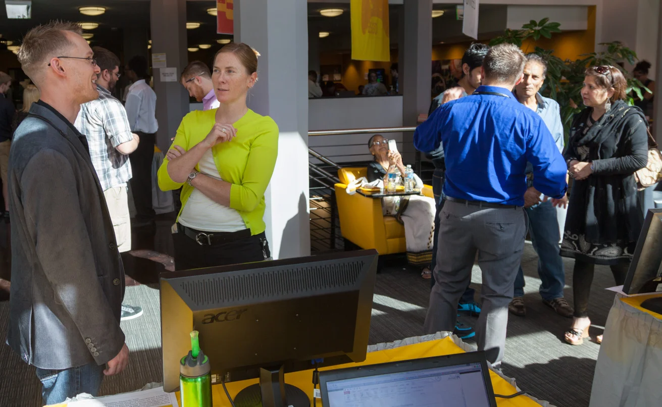 Dean of Students Erin McCormack speaks with a student about his project at Project Showcase. 