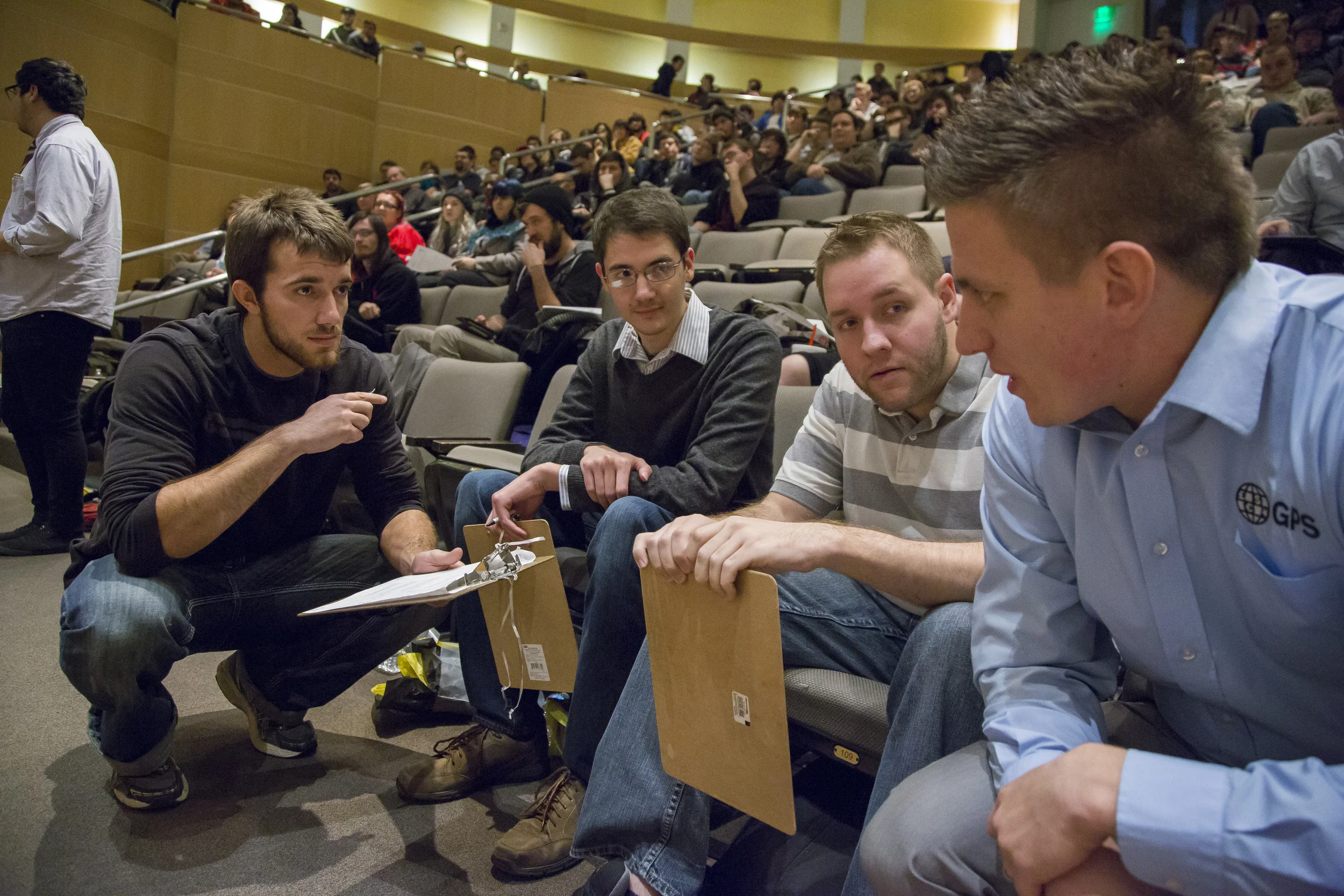 Kevin (center) and other alums judge current student projects at the 2015 December Capstone Project Invitational. 