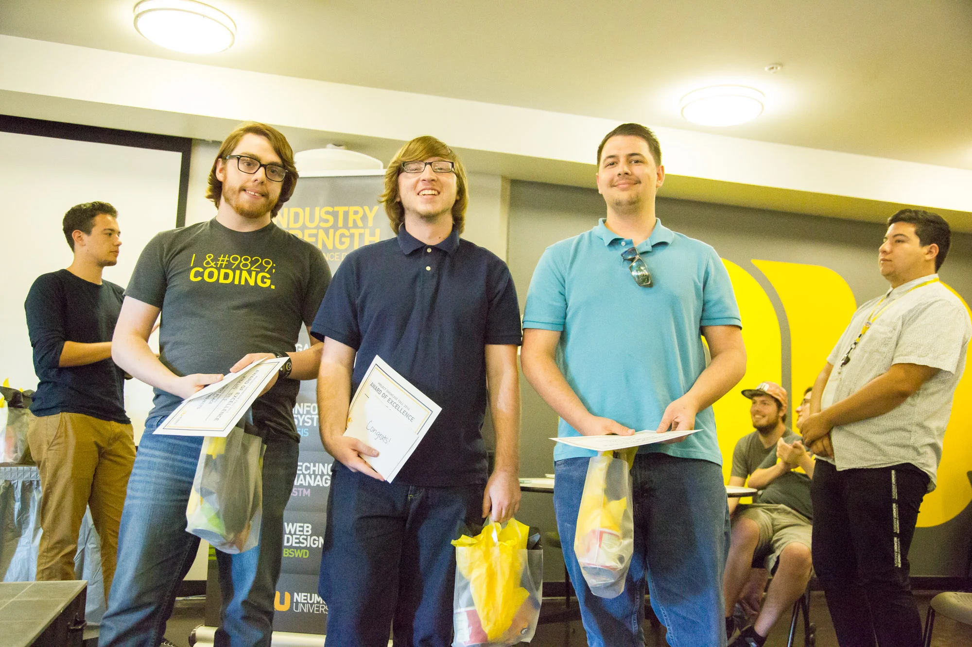 The team behind the winning game accept their prizes. 