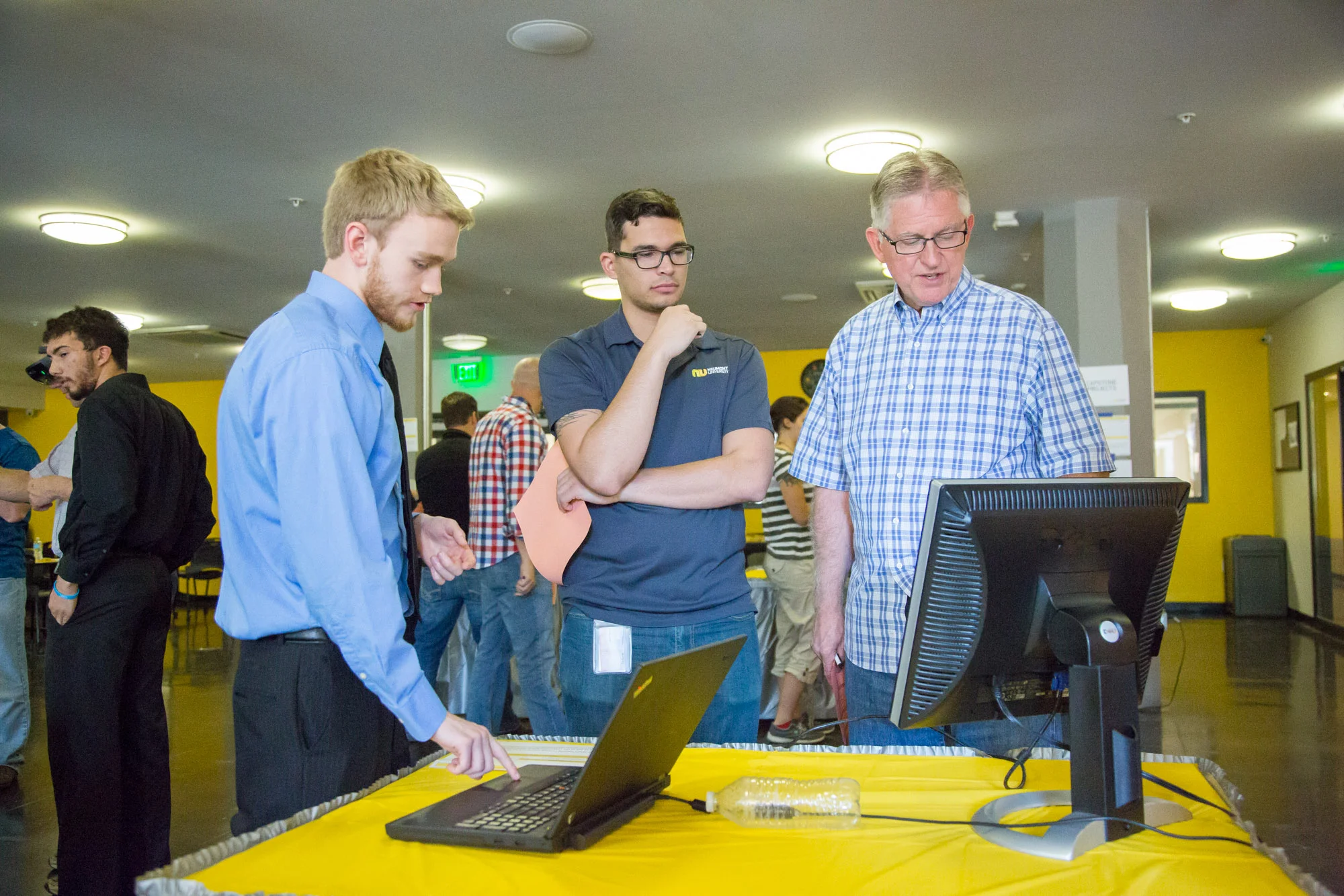 Tyler Berry shows his project, NU Code to staff. 