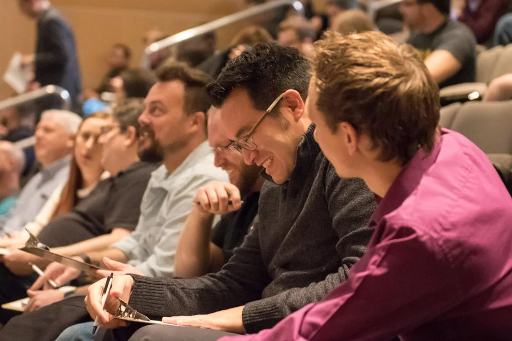 Industry partners from companies like RizePoint, DealerSocket, and Workfront listen to 5 students demo their projects at Capstone Project Invitational. 
