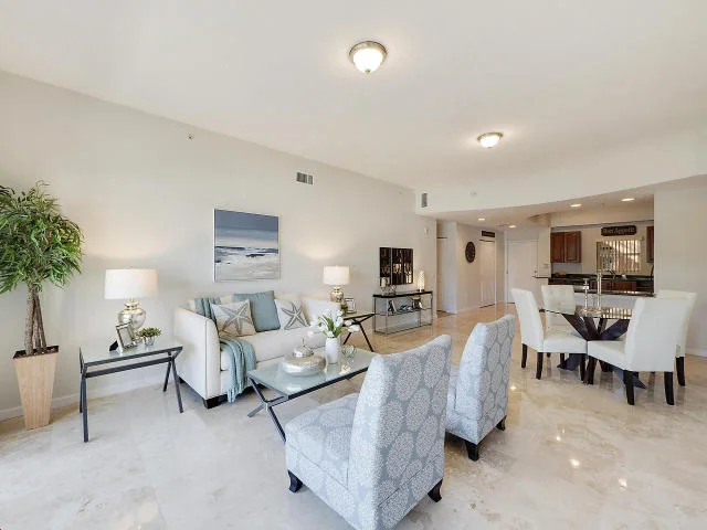 Click Photo for MLS Listing Info Click for Video Tour Professionally Staged by Kathie Kime of Palm Beach Staging Two Spacious Units combined creating 2,600 sq ft of absolute luxury living! Perfect for multi-generational families or home office. Shows beautifully--Professionally staged. Open Floor plan. 3 Bedrooms (2 Master suites), 3 Baths. Large Kitchen with Granite & Stainless Steel Appliances. Living/Dining Room, Separate Family Room plus Office/Den with private entrance. Gleaming 18''x 18'' porcelain-travertine flooring. New plush carpeting in bedrooms. 10' Ceilings. Lots of storage space. Community amenities include On-Site Management, Gated Entry, Security Guard, Pool, Fitness Center, Clubhouse & Sauna. Fantastic location - near PBI Airport, the Outlet Mall, Whole Foods, 2.5 miles to City Place, 3.5 miles to Beach.