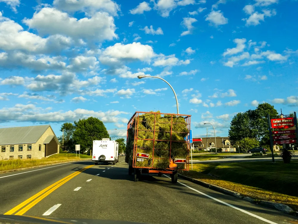 Traffic slowed up a bit entering ile de Orleans when this hay truck turned onto the road - Mobile photo (edited in Lightroom)