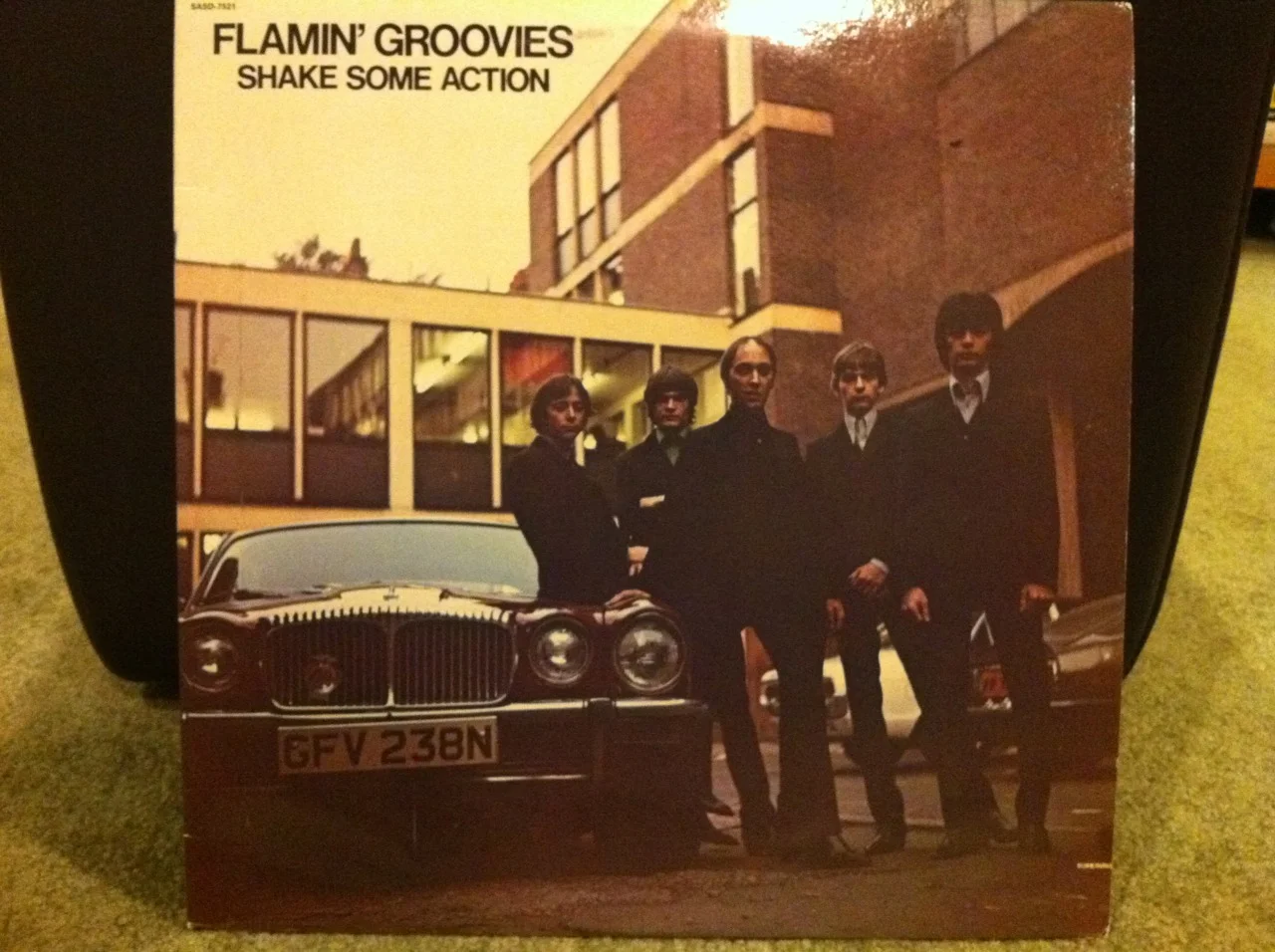 Bust Out At Full Speed!!!
The Flamin’ Groovies are one of the most awesome (if slightly confusing) bands ever! I’ll cover the confusion in the For Weirdos Only section below. This long-player - Shake Some Action - is my favorite Flamin’ Groovies album. Of the second era. This is the Cyril Jordan led version of the band with Chris Wilson singing vocals. It sounds real treble-y and jangle-y and super rocking. To my ears it sounds like The Beatles married Bob Dylan and gave birth to their baby - the Flamin’ Groovies - on a flamin’ red Rickenbacker 12 string electric guitar.
Every time I listen to this album it takes me back to junior high. I remember gambling on this album because it looked so cool and it was on the Sire label. I loved the Ramones and the Talking Heads at the time and they were on Sire so I thought these Flamin’ Groovies had promise. And promise they did. They promised to kick me in the arse with every listen. They rocked hard and there’s not a weak song on this record. Not one.
There’s only one weak thing about this album in my opinion. It sounds like it was recorded beneath a million cotton balls inside a gauze wrapped cocoon of felt. Maybe I’m exaggerating. This is one of very few instances where I think the recent Rhino UK collection “Flamin’ Groovies At Full Speed: The Complete Sire Recordings” sounds better on compact disc. If you know me, then you know I love the sound of wax. Vinyl. The LP. The rekkid. But this one sounds better on this new CD collection.
Flamin’ Groovies At Full Speed: The Complete Sire Recordings is a great deal because it sounds awesome, you get some unreleased and rare tracks and if you don’t buy it you’ll be making a huge mistake. It contains all three of their mind-blowing Sire records - Shake Some Action, Flamin’ Groovies Now and Jumpin’ In The Night. Trust me. They’re awesome. Three slabs of wax on two compact discs. Do it!
In large part, I credit the Flamin’ Groovies with getting me interested in a band I’ll cover in much detail later - The Beatles.
For Weirdos Only: Shake Some Action came out in 1976. It was their first new LP of new music since 1971’s Teenage Head (my favorite album of the 1st era). Shake Some Action’s sound is nothing like that of the first era Flamin’ Groovies. That band had a harder Stones-y rockabilly edge that was amazing in it’s way. I happen to love both eras - the Roy Loney/Cyril Jordan led first era and the Cyril Jordan/Chris Wilson led second era.
For Weirdos Only (part 2): If you look closely, you can see a small (¾") horizontal slice in the album jacket at bottom right. Cheapskate rock ‘n’ rollers will recognize this right away as a “cut-out” record. For the uninitiated, you could find bins and bins of these “cut-out” records at your local record store for between $1 - $4 or so back in the 70s and 80s. They were records that didn’t sell well and were “cut” to render them identifiable as cut-outs and then sold cheap to get rid of them. That’s how I found this record. Most likely next to a Fleetwood Mac Tusk album. Yuck.
Here’s an audio-only sample from Shake Some Action: http://www.youtube.com/watch?v=L2Y5LKZPwV4