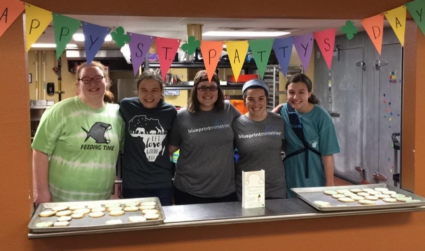 (From left to right) Abby, Janae, Taylor, Abby, and Hope serve a St. Patrick's Day treat to our spring break campers.