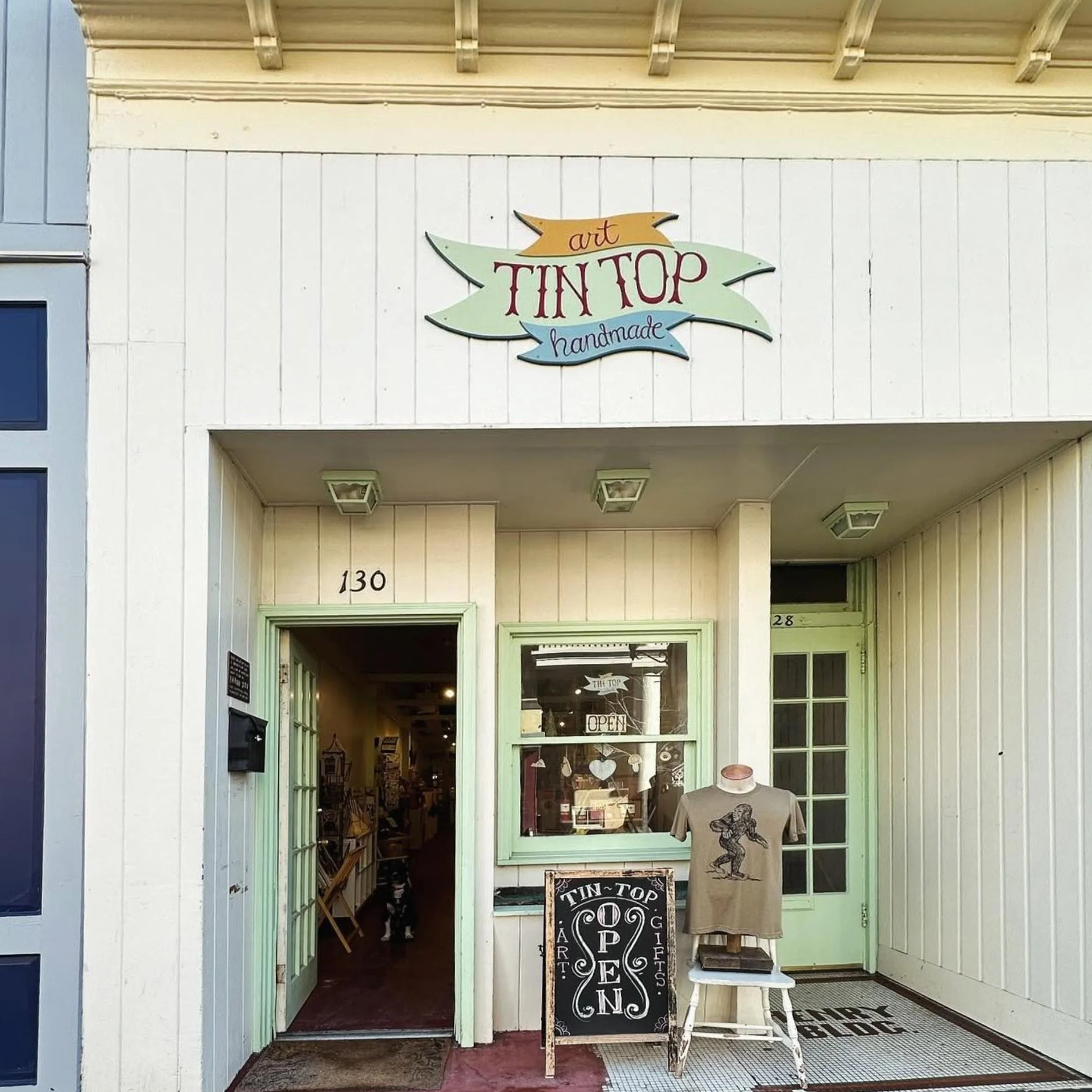 gift shop on walking mall in winchester, va with a variety of handmade goods featuring a graphic t-shirt outside store.