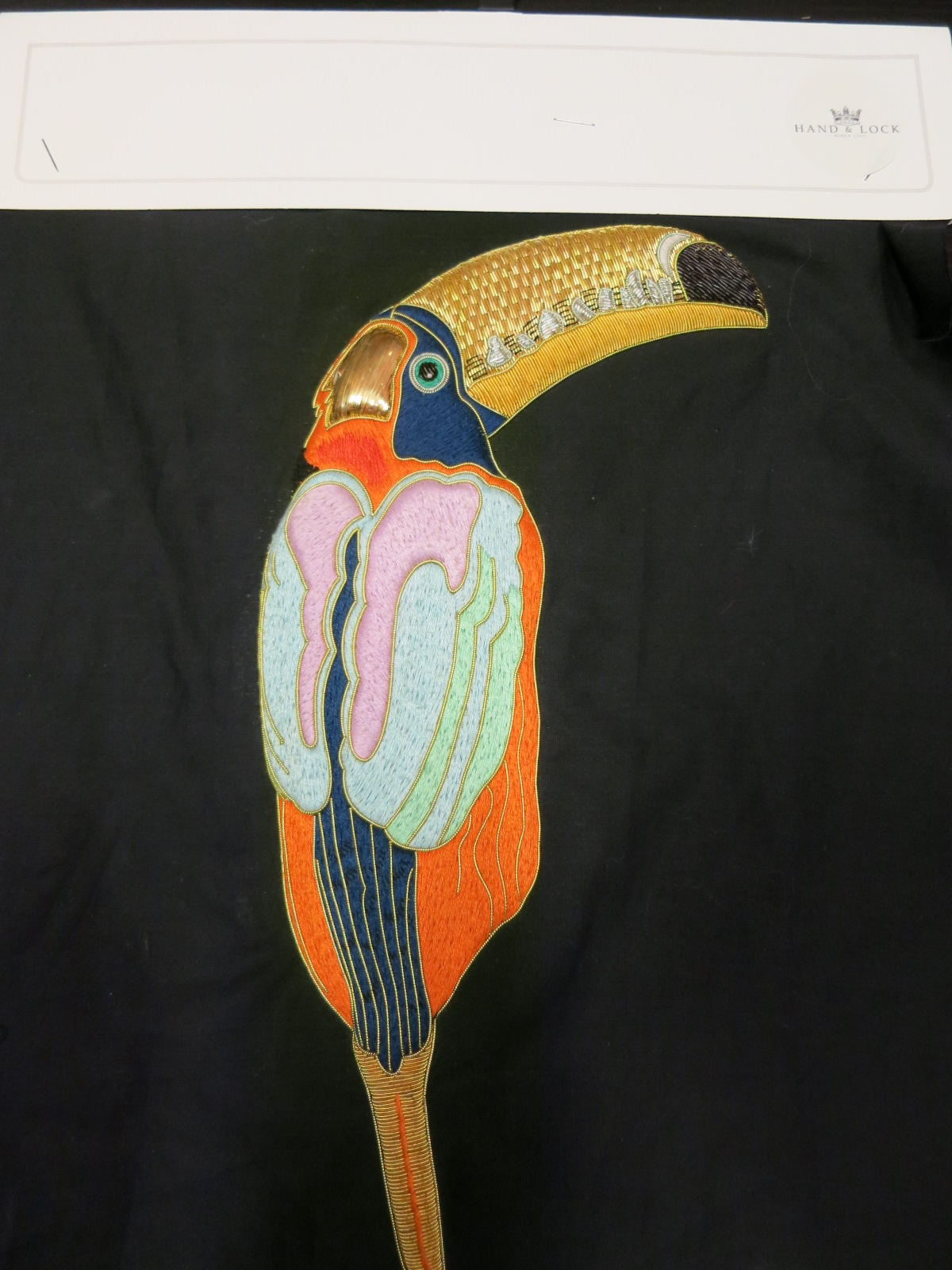 An embroidered sample at Hand & Lock