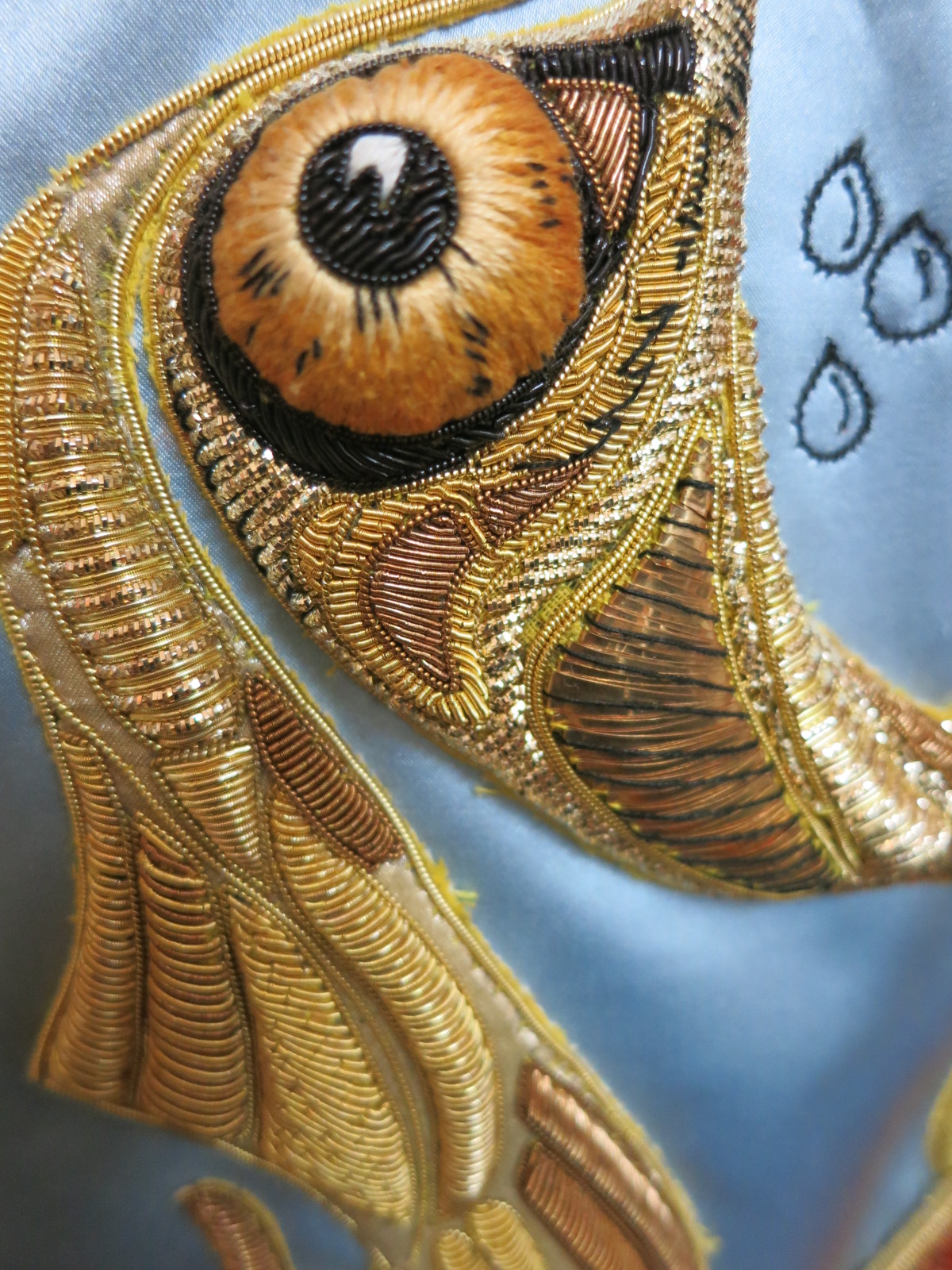A detail of an embroidered garment in a Hand & Lock Collection