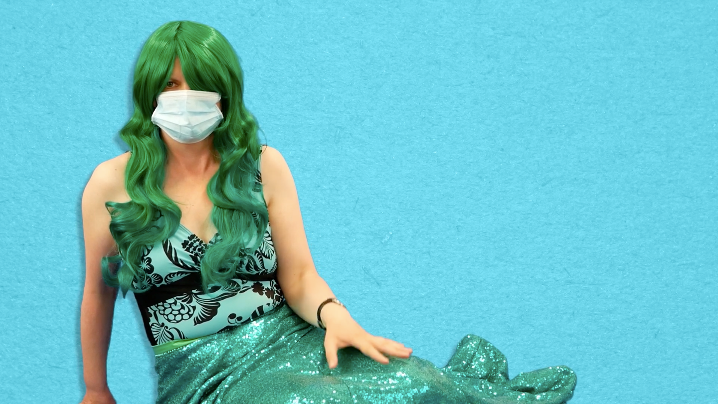 A mermaid wearing a face mask