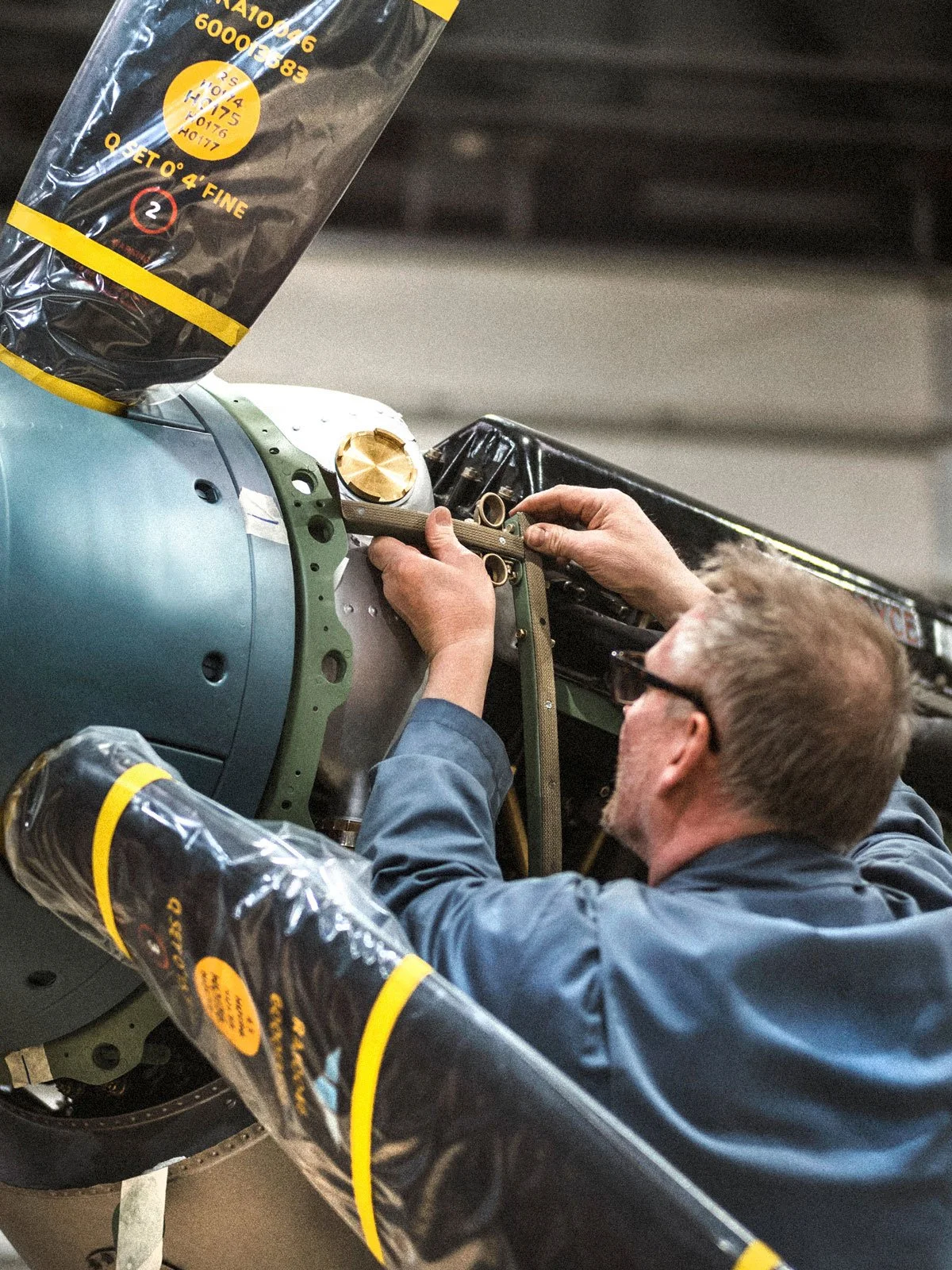 AircraftRestorationCo_Engineer-Fabricating-Engine-Cowling-Restoration-Spitfire-Duxford-Airfield_by-GeorgeLewisRomain.jpg