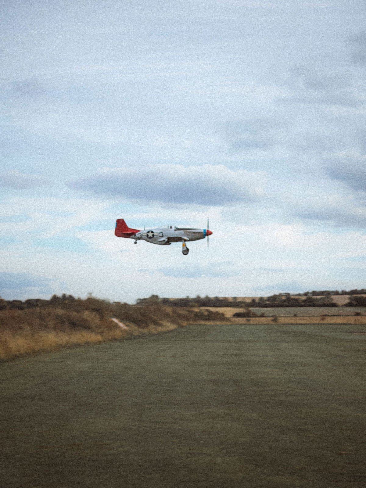 AircraftRestorationCo_P51-Mustang-Tall-in-the-Saddle-approach-to-land-IWM-Duxford-Airfield_by-JackHolt.jpg