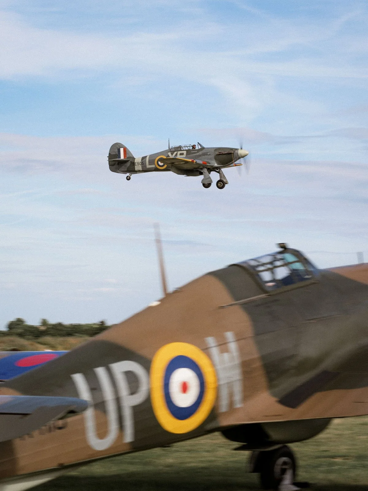 Hawker Hurricane IIB BE505 coming into land at Duxford Airfield over Hurricane R4118.
