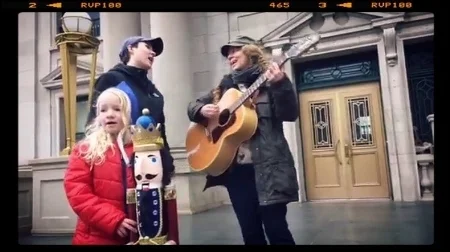 A screenshot from a live video that Maze, her little Guru, and I filmed of us singing for peace on the courthouse steps in Albany, NY.