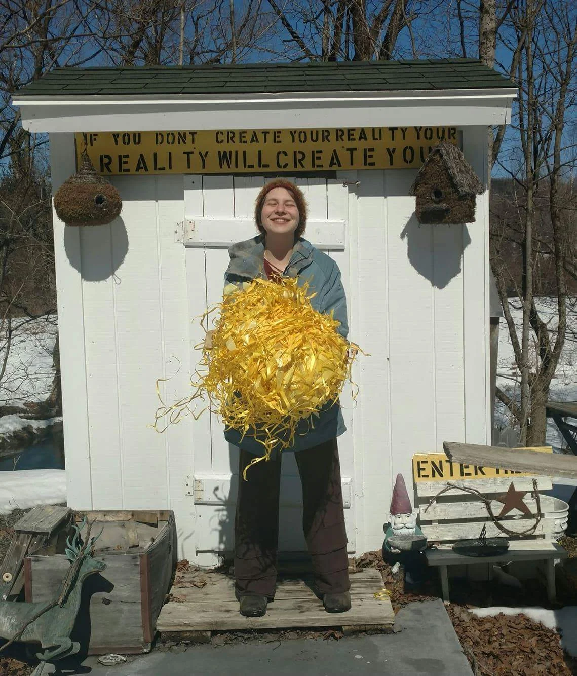 MamaDala holding the Ball of Peace outside of the Tiny Creality Shop at the Camp Now Art Farm 